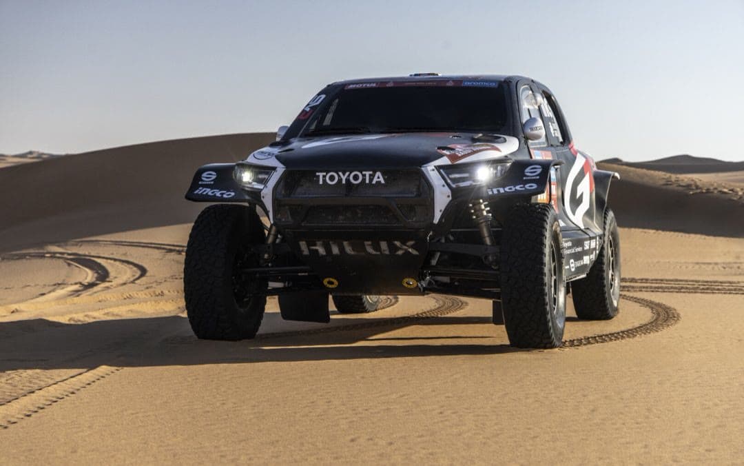 The Toyota Hilux rally car in the dunes